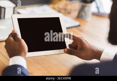 Cropped image of businessman touching blank digital tablet screen Stock Photo