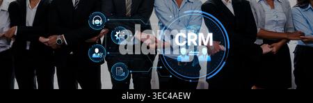 Diverse professionals in business attire collaborating on a CRM strategy, highlighting teamwork and technology in a modern office setting. Perfect for Stock Photo