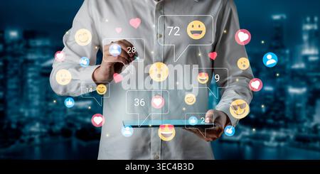 A person interacts with a tablet displaying various social media icons and emoji reactions, set against a beautiful urban night skyline, illustrating Stock Photo