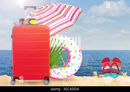 Bright suitcase, swim ring, sun umbrella and flip flops on beach Stock Photo