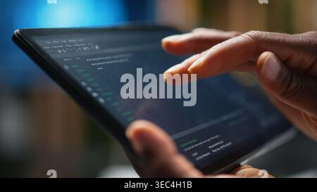 Close up of IT specialist using tablet in office, working with programming languages. Programmer using device in company workplace to do hardware systems quality assurance Stock Photo