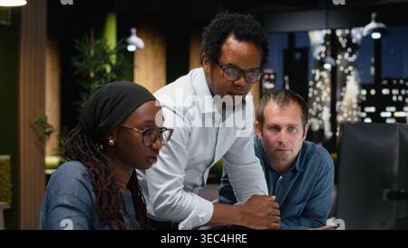 Programmers working together in Silicon Valley company office, developing apps. Coworkers doing brainstorming, using machine learning to do coding, debugging applications to resolve issues Stock Photo