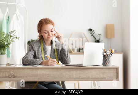 Female tailor talking on mobile phone with customer Stock Photo