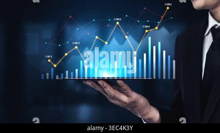 A business person presents a tablet displaying a vibrant digital chart with rising graphs, symbolizing financial growth and data analytics in today Stock Photo