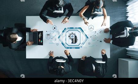 A business team uses virtual reality technology to collaborate in a modern office, analyzing data and discussing strategies for innovation and growth Stock Photo