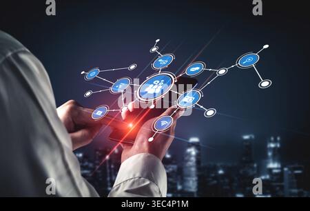 A person holds a smartphone displaying connection icons in a dynamic urban setting. This image symbolizes modern digital communication and social Stock Photo