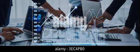 Business professionals analyze financial data and graphs on digital devices in a modern office, focusing on growth indicators and collaborative Stock Photo