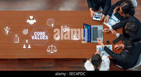 Collaborative Team Meeting with Graphics Representing Core Values and Business Strategy on a Wooden Table Fluxor. Stock Photo