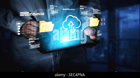 A person holds a tablet that displays a futuristic cloud upload interface with icons and data files. The image captures the essence of modern Stock Photo