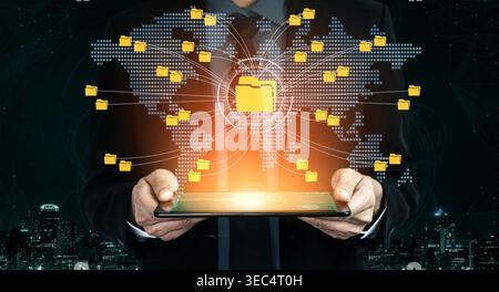 Businessman Holding Tablet with Digital Connection to Global Network of Folders and Icons Representing Data Management and Technology in Modern Stock Photo