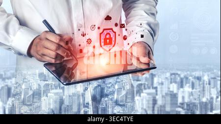 Businessperson Using Digital Tablet with Security Icon Illustrations Over Cityscape Background for Cybersecurity Concept Quark. Stock Photo