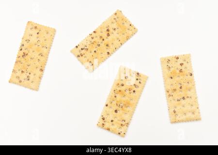 Four pieces of black truffle ham soda biscuits on a white surface. Stock Photo