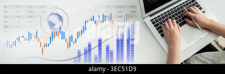 This image showcases hands typing on a laptop, with stock market graphs and data charts in the background, symbolizing finance and data analysis in a Stock Photo