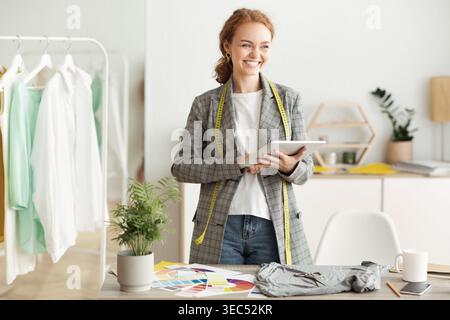 Fashion designer drawing new sketches collection on tablet Stock Photo