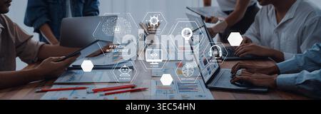 A dynamic office scene showcasing teamwork and technology with individuals engaged in discussion, using laptops and tablets for data analysis and Stock Photo