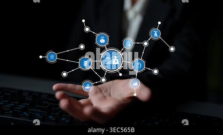 This image depicts a modern digital tax network with finance-related icons on a user hand, symbolizing money management, technology, and data Stock Photo
