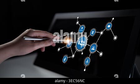 A hand interacts with a digital touchscreen, showcasing a network of connected icons that symbolize data visualization and technology innovation in a Stock Photo