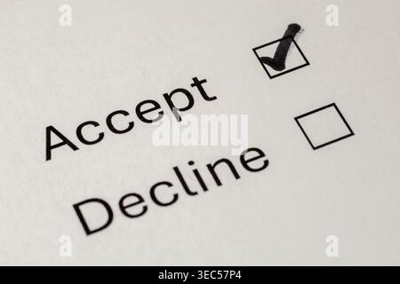 Close-Up of Paper Form with Accept or Decline Option, Accept Checkbox Ticked Stock Photo