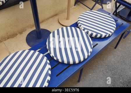 Stripes on seats in a casual outdoor area near a building Stock Photo