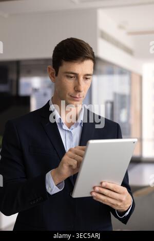 Young male executive working on modern tablet device Stock Photo