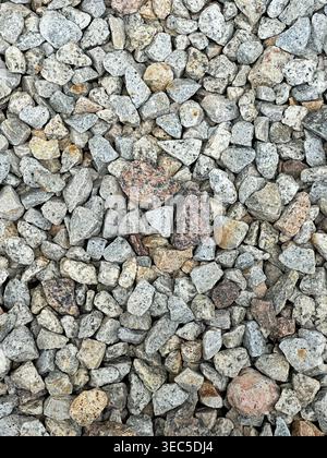 Close up of crusher run gravel showing rough stone texture with mixed gray and beige crushed rocks. Stock Photo