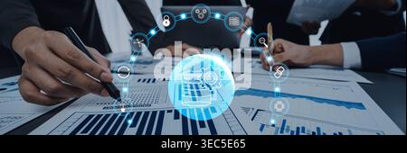 A dynamic business team works together to analyze charts and graphs, highlighting technology and analytics in a collaborative office setting. Perfect Stock Photo