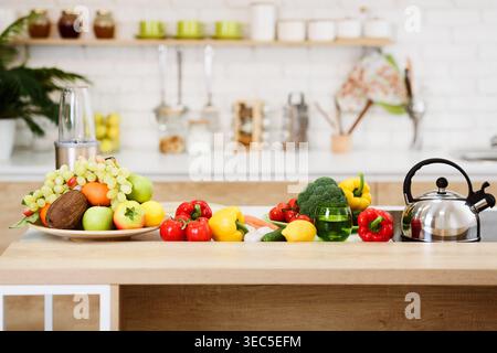 Fresh Vegetables And Fruits On Kitchen Table Stock Photo
