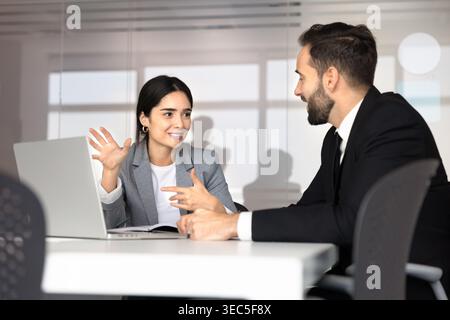 Professional female manager consulting male client in office Stock Photo