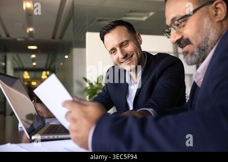 Business partners reviewing documents at office desk Stock Photo