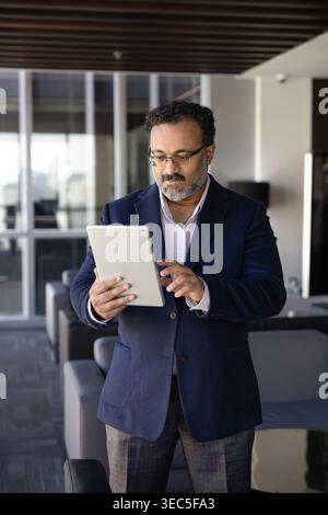 Business professional reviewing digital data on tablet Stock Photo