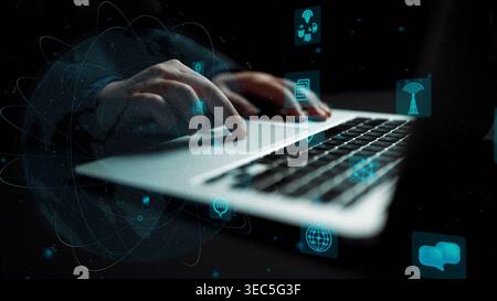 A person interacts with a laptop in a modern workspace, with digital icons emphasizing technology and connectivity, showcasing innovation in Stock Photo