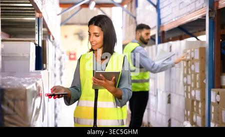 Warehouse worker scanning barcode, check inventory in distribution center Stock Photo
