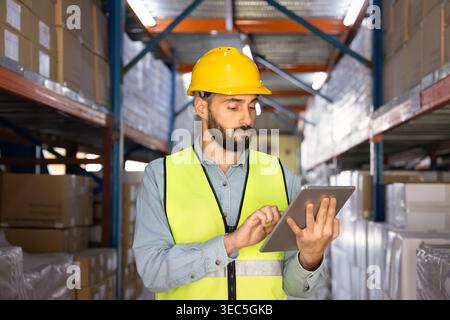 Warehouse worker using digital tablet for inventory management  Stock Photo