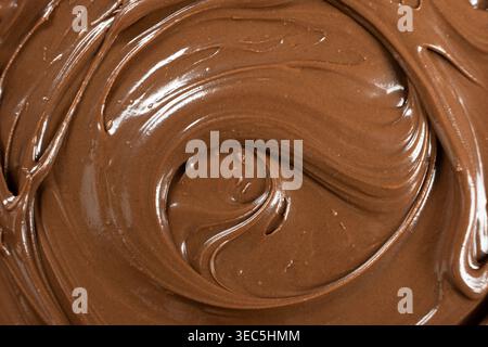 Creamy delicious chocolate melted cream texture background top view. Stock Photo