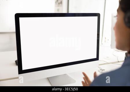 Closeup of blank computer screen at modern office desk Stock Photo