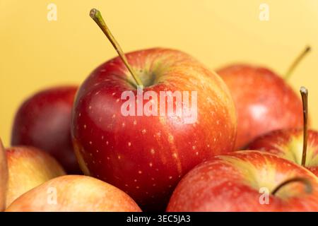 Ripe red apples on a yellow background for healthy eating Stock Photo