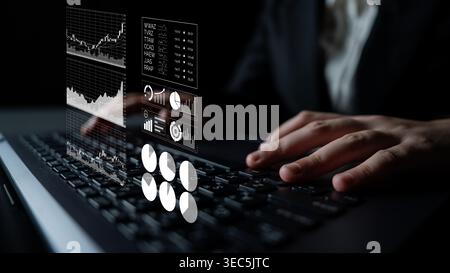 A business professional engages in data analysis using a laptop, with visible charts and graphs illustrating critical financial metrics and market Stock Photo