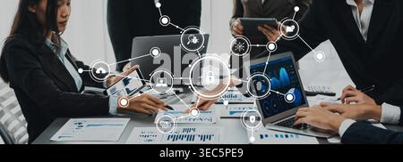 A dynamic team works together on cybersecurity strategies using digital tools and data analysis in a modern office setting, enhancing collaboration Stock Photo