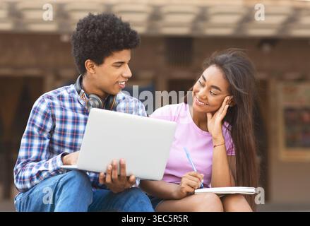Students Collaborating on a Project at an Outdoor Location in Daylight Stock Photo