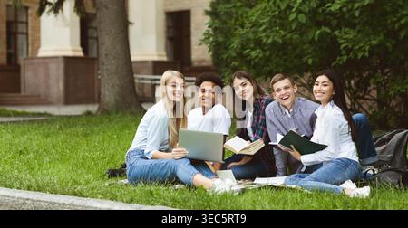 University students resting in campus, smiling to camera Stock Photo
