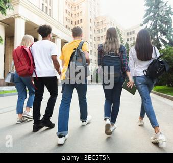 Group of students walking together in campus after studies Stock Photo