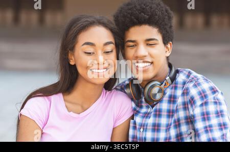Young Couple Enjoying a Happy Moment Together Outdoors in a Relaxed Setting Stock Photo