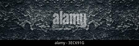Black concrete wall wide texture. Hardened cement mortar drips. Dark gray roomy background Stock Photo