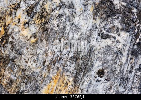 Beautiful rough rock texture stone natural mineral background showing fascinating granite geology surface with abstract gray and gold pattern conveyin Stock Photo