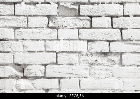 White painted old brick wall texture. Bleached rough aged brickwork. Niveous light background Stock Photo