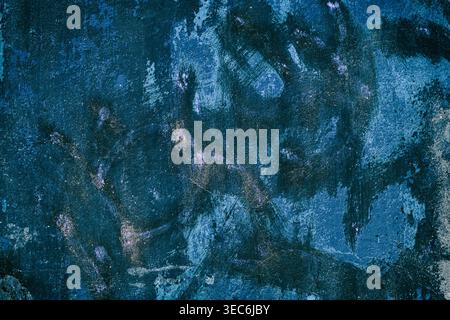 Abstract grunge background. Concrete wall covered with deep blue paint smears Stock Photo