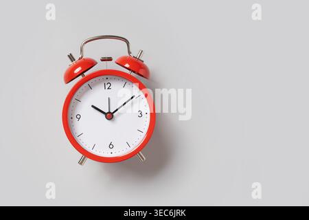 Red alarm clock on light background with copy space, time management and deadline concept, productivity and planning idea Stock Photo