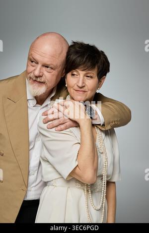 A happy senior couple shares a warm embrace, showcasing their enduring love and connection. Stock Photo