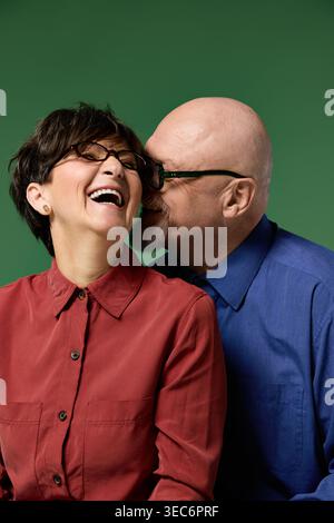 A couple enjoys a tender moment together, laughing and sharing love in a playful embrace. Stock Photo