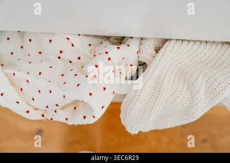 Close-up of neatly folded clothes inside a drawer. Home organization and minimal lifestyle concept with soft natural light and clean interior. Stock Photo